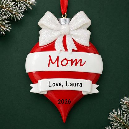 Personalized mom red christmas ornament on a dark green pine background