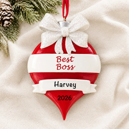 Personalized best boss christmas ornament laid on a soft white knit blanket