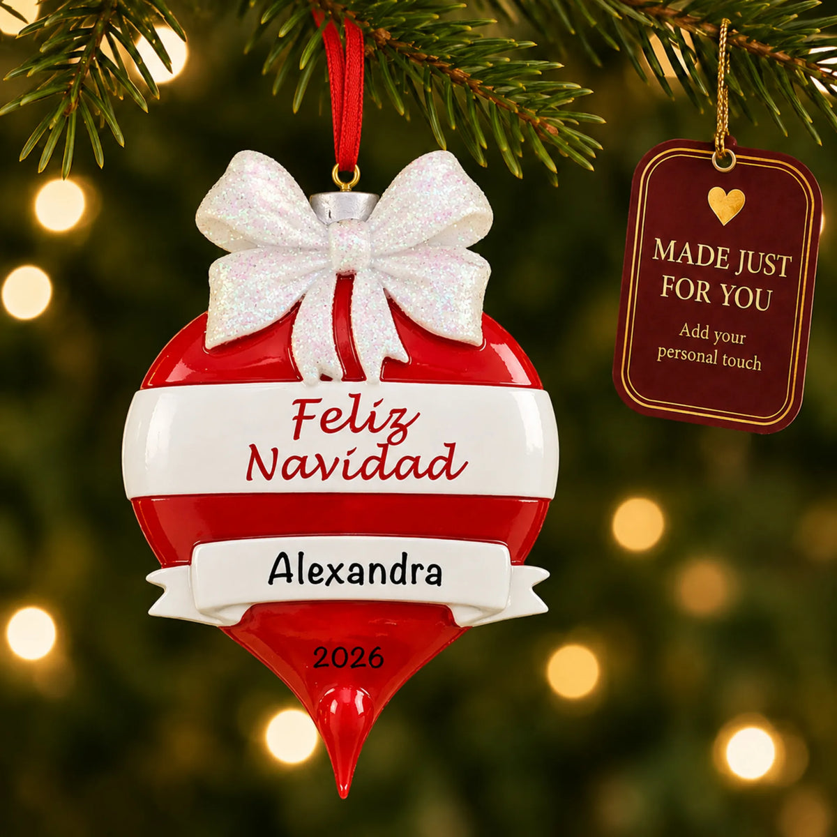 Feliz Navidad christmas ornament hanging on a lit Christmas tree with a Made Just For You gift tag