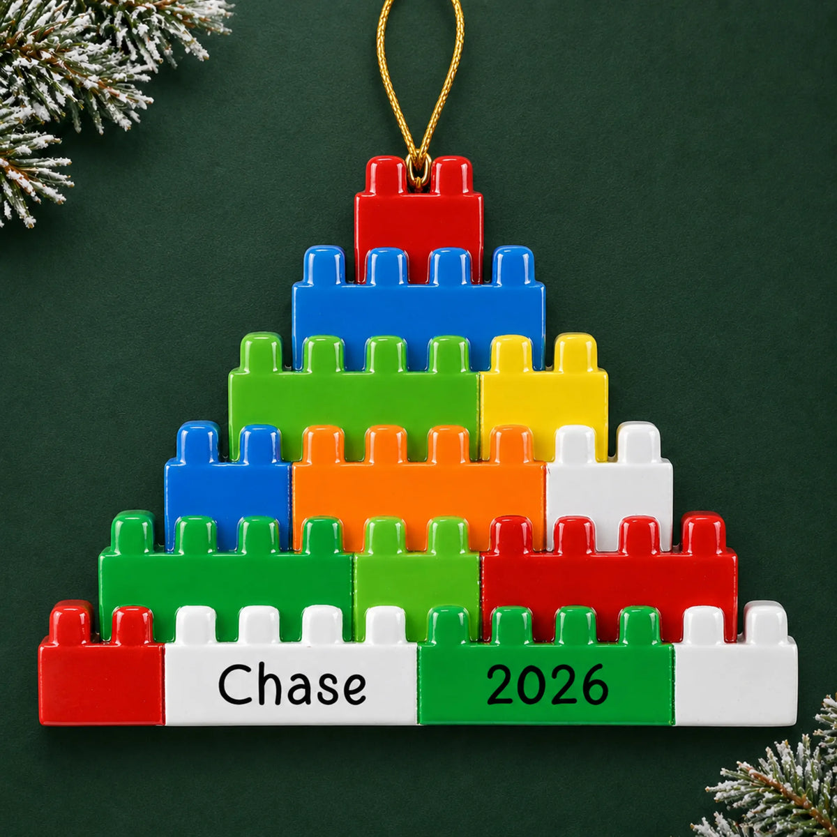 Personalized building blocks christmas ornament on a dark green pine background