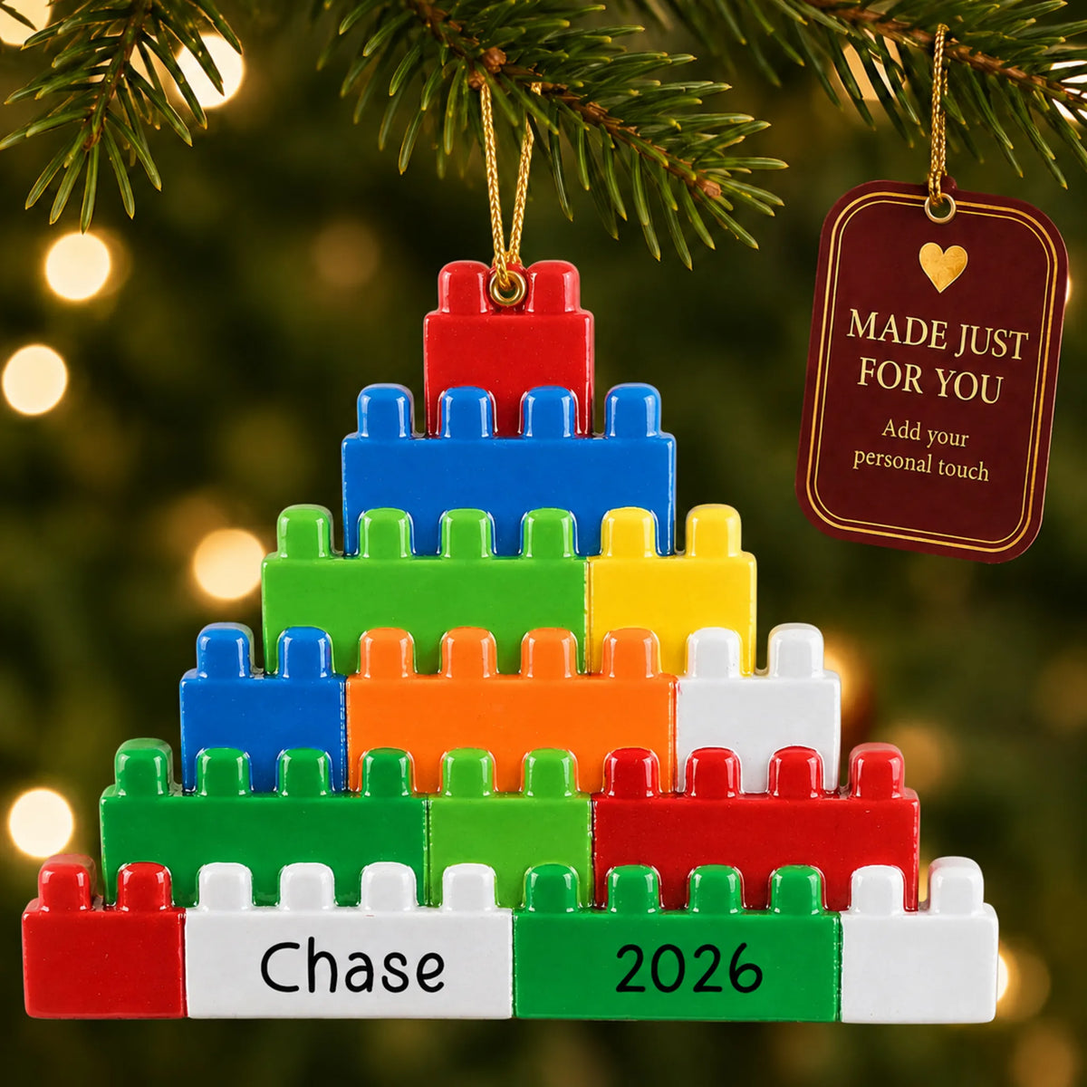 Building blocks christmas ornament hanging on a lit Christmas tree with a Made Just For You gift tag