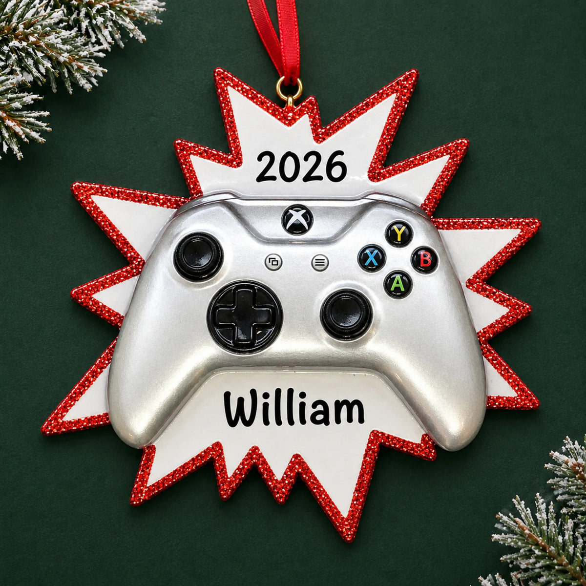 Personalized silver video game controller christmas ornament on a dark green pine background