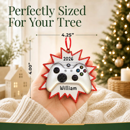 Size guide: the personalized silver video game controller christmas ornament is 4.25 in wide by 4.00 in tall, shown in hand