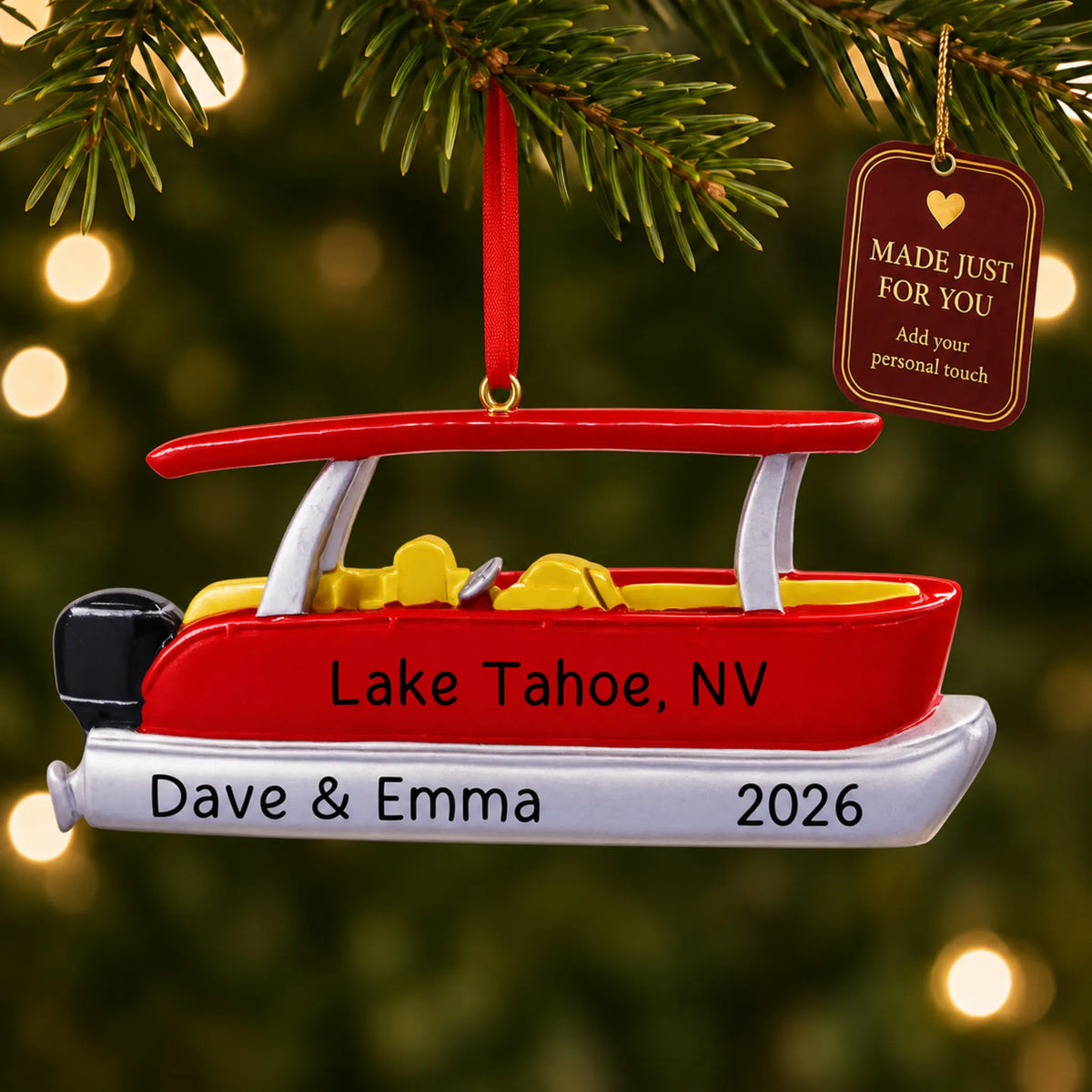 Red pontoon boat christmas ornament hanging on a lit Christmas tree with a Made Just For You gift tag