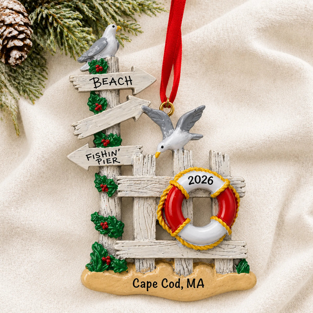 Personalized beach gate christmas ornament laid on a soft white knit blanket