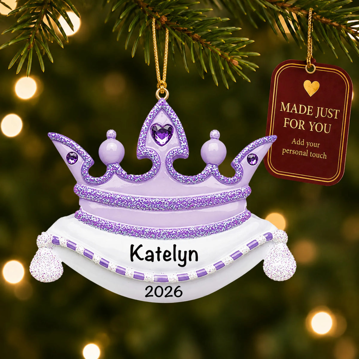 Purple princess crown christmas ornament hanging on a lit Christmas tree with a Made Just For You gift tag