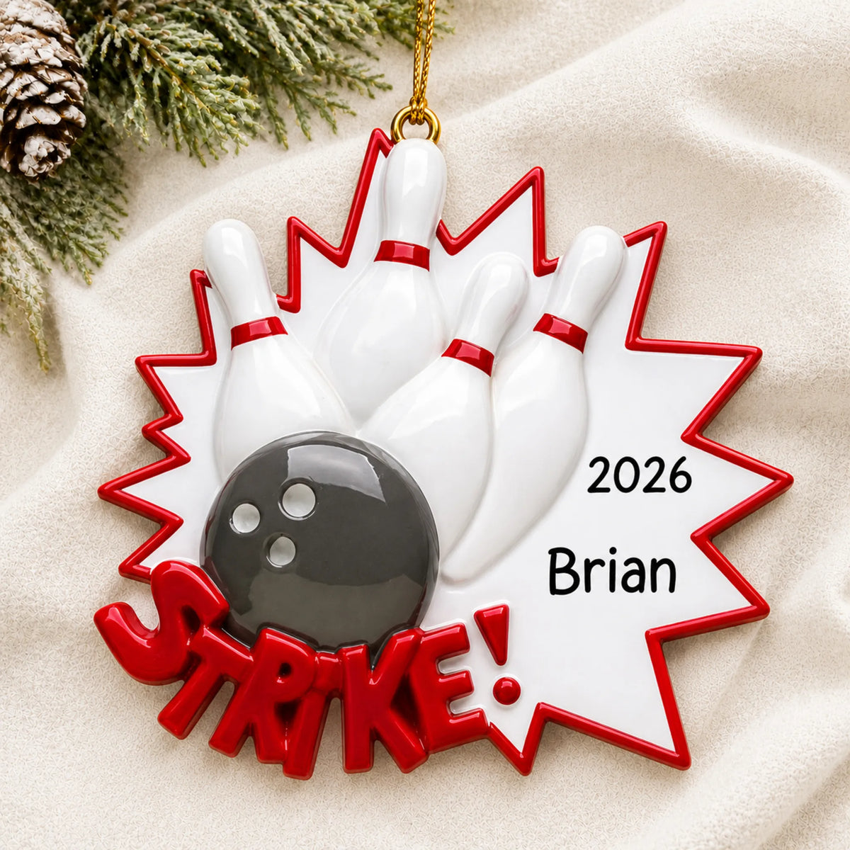 Personalized Bowling christmas ornament laid on a soft white knit blanket
