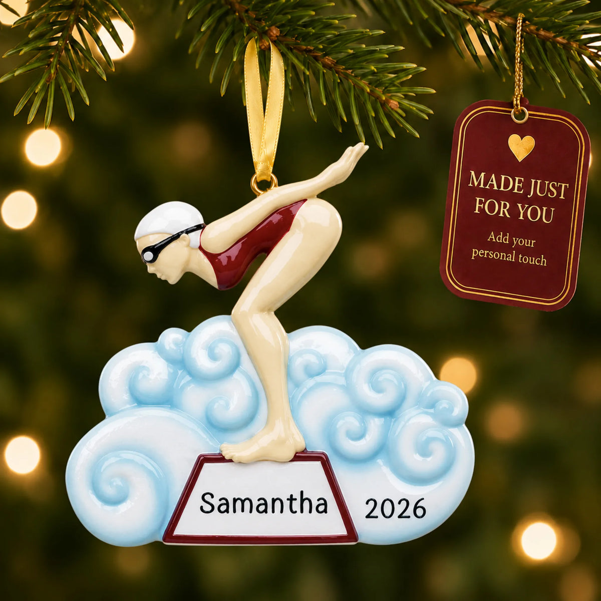 Girl swimmer christmas ornament hanging on a lit Christmas tree with a Made Just For You gift tag