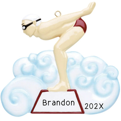 Personalized Christmas ornament featuring a male swimmer in red trunks, cap, and goggles, poised on a starting block above a blue water cloud, ready for custom engraving.