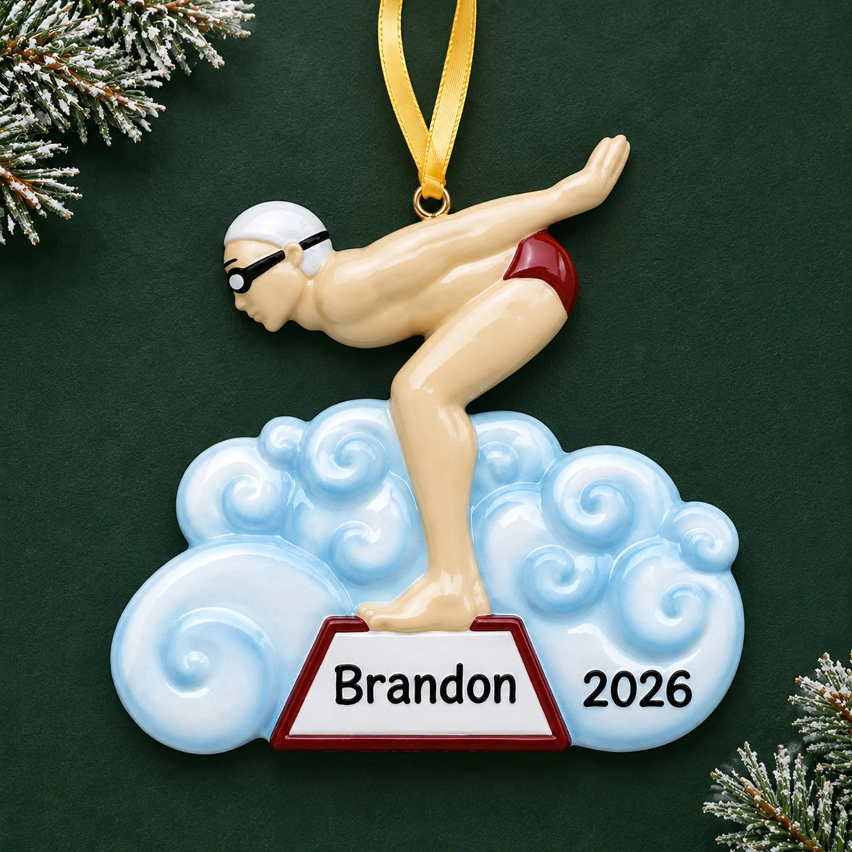 Personalized boy swimmer christmas ornament on a dark green pine background