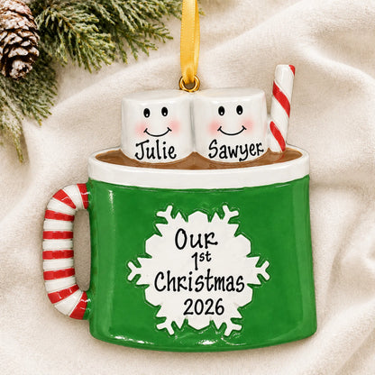 Personalized hot cocoa couple christmas ornament laid on a soft white knit blanket