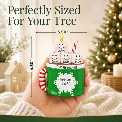 Size guide: the personalized hot cocoa family of 4 christmas ornament is 3.50 in wide by 4.50 in tall, shown in hand
