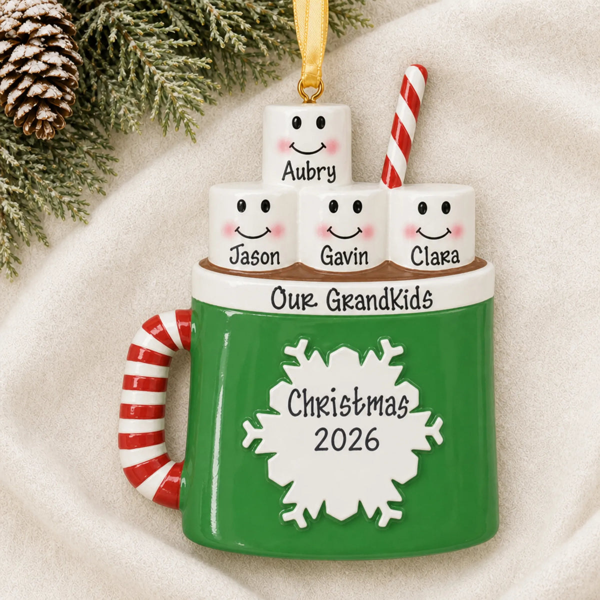 Personalized hot cocoa family of 4 christmas ornament laid on a soft white knit blanket