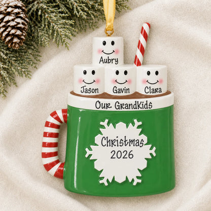 Personalized hot cocoa family of 4 christmas ornament laid on a soft white knit blanket