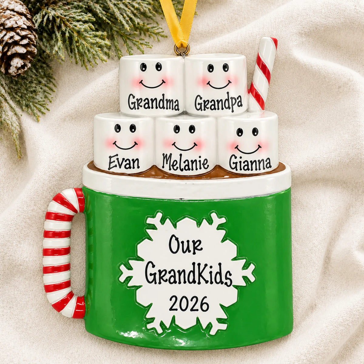 Personalized hot cocoa family of 5 christmas ornament laid on a soft white knit blanket