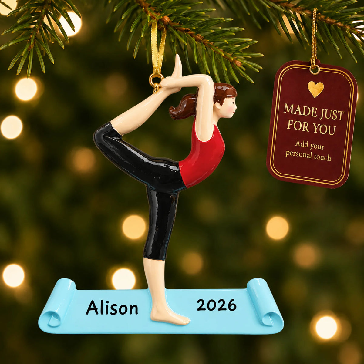 Yoga christmas ornament hanging on a lit Christmas tree with a Made Just For You gift tag