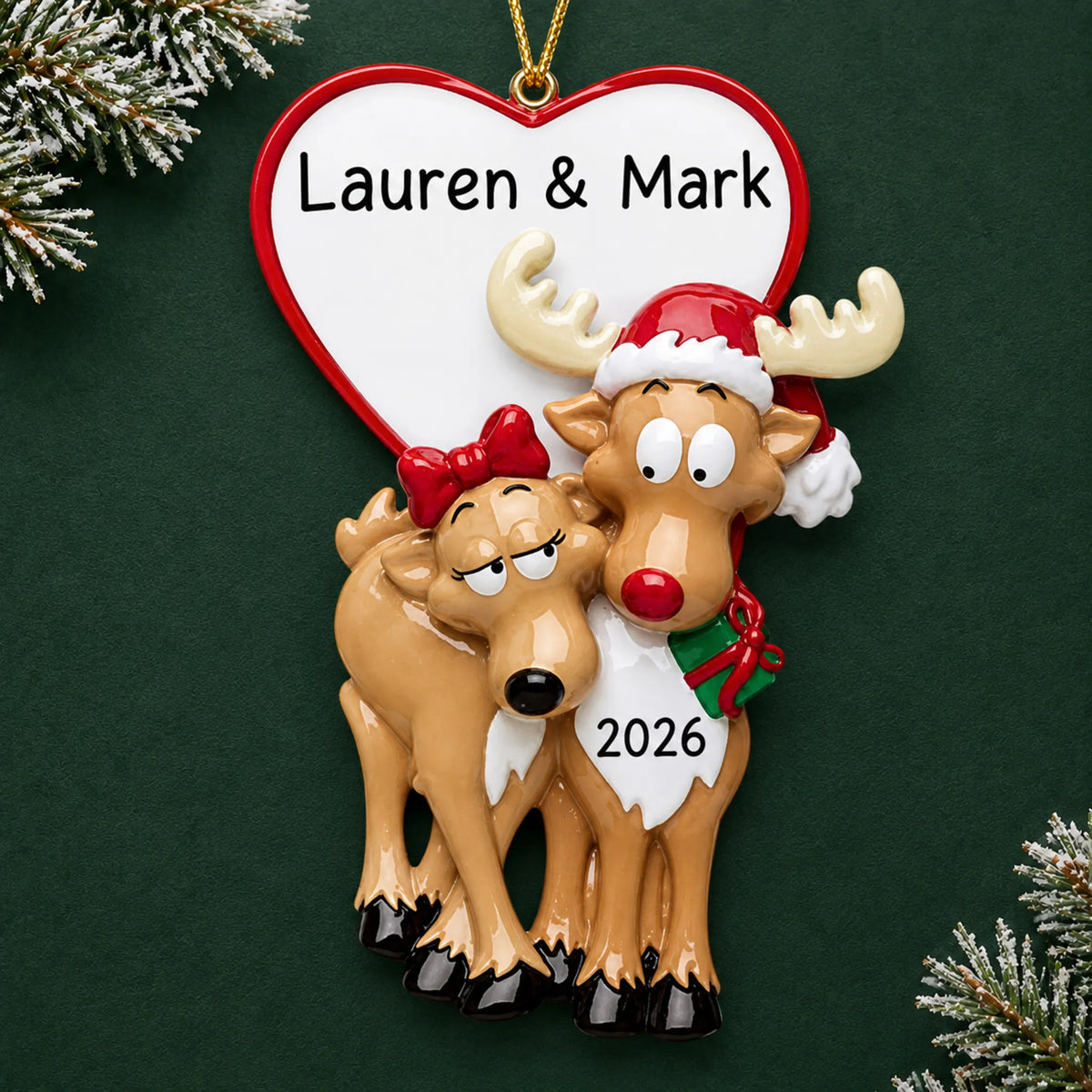 Personalized reindeer couple christmas ornament on a dark green pine background