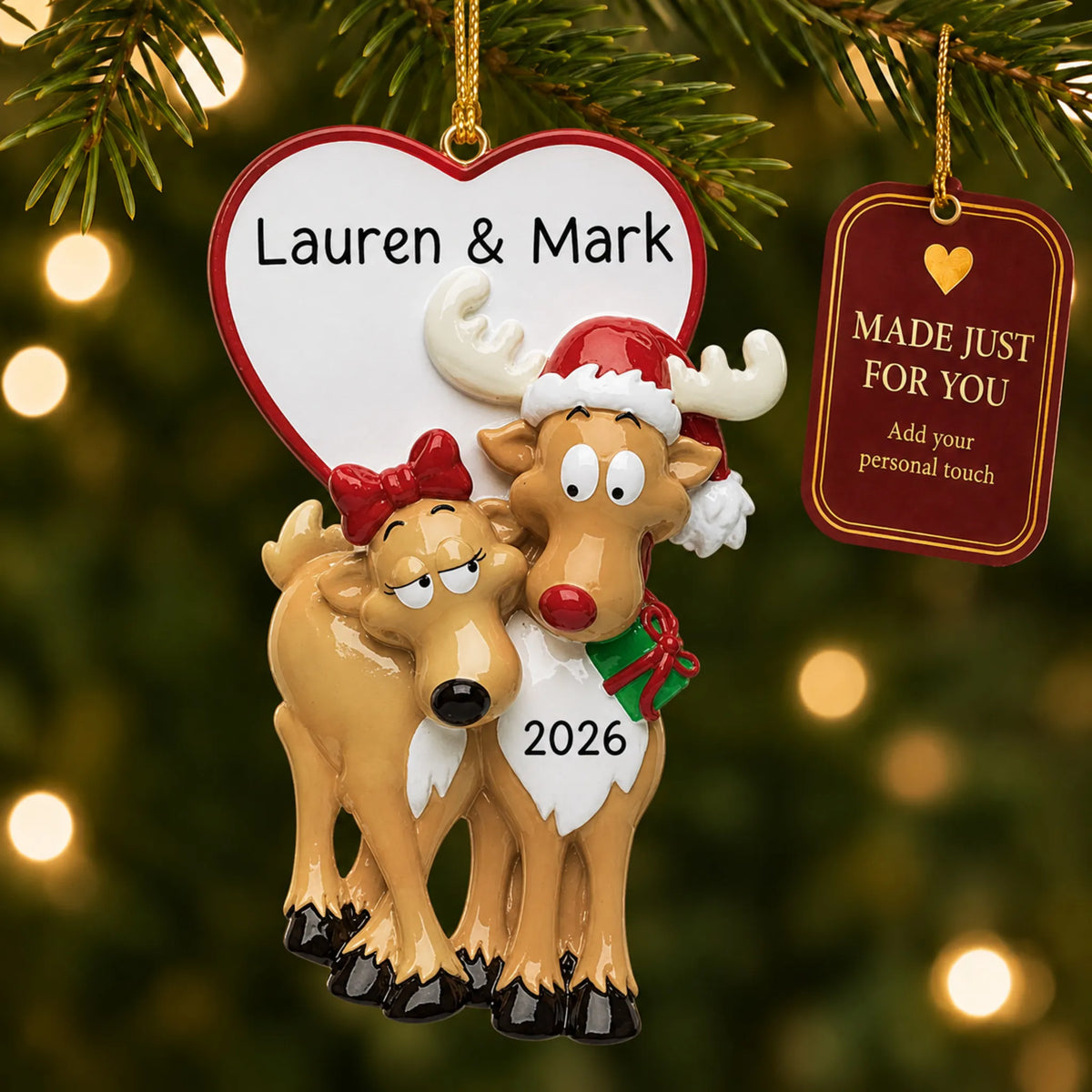 Reindeer couple christmas ornament hanging on a lit Christmas tree with a Made Just For You gift tag