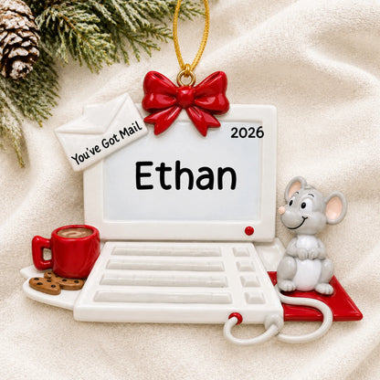 Personalized computer and mouse christmas ornament laid on a soft white knit blanket