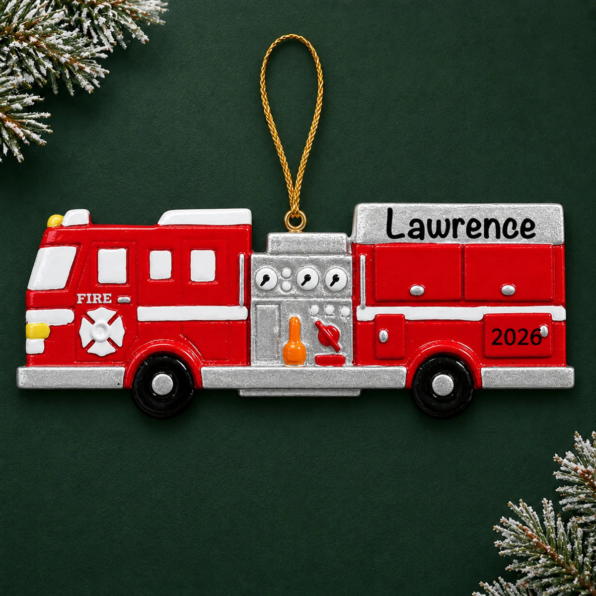 Personalized fire engine christmas ornament on a dark green pine background