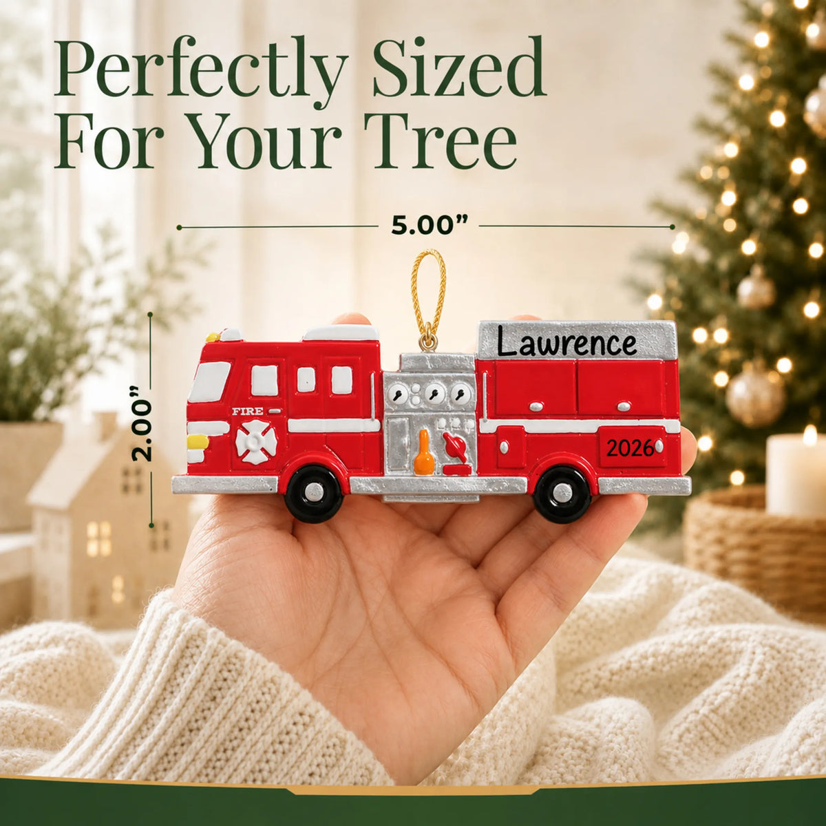 Size guide: the personalized fire engine christmas ornament is 5.00 in wide by 2.00 in tall, shown in hand