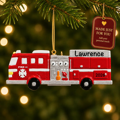 Fire engine christmas ornament hanging on a lit Christmas tree with a Made Just For You gift tag