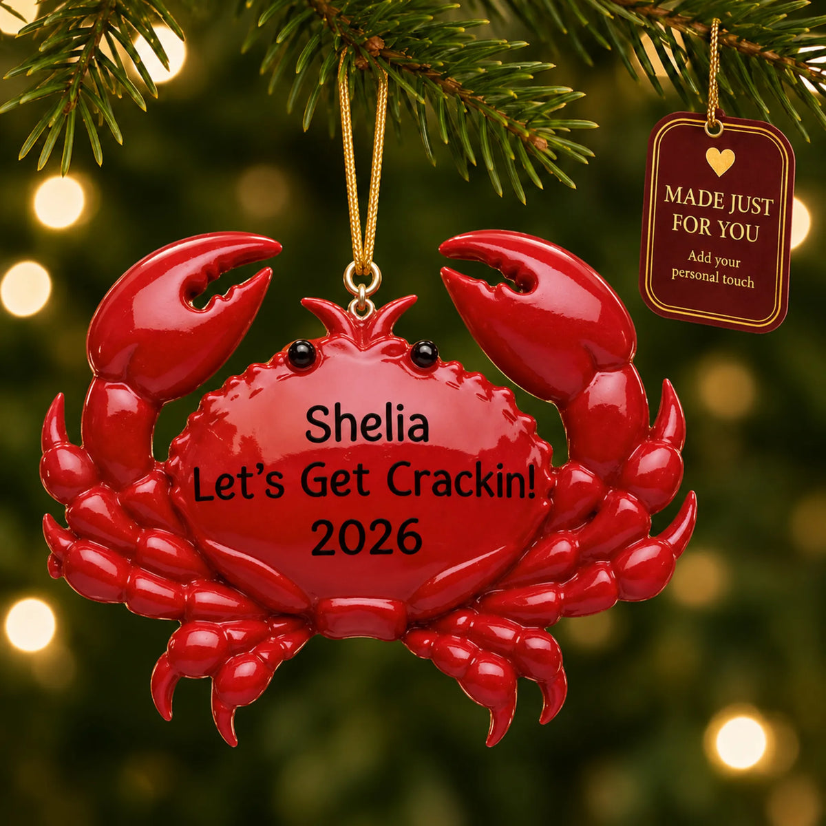 Crab christmas ornament hanging on a lit Christmas tree with a Made Just For You gift tag
