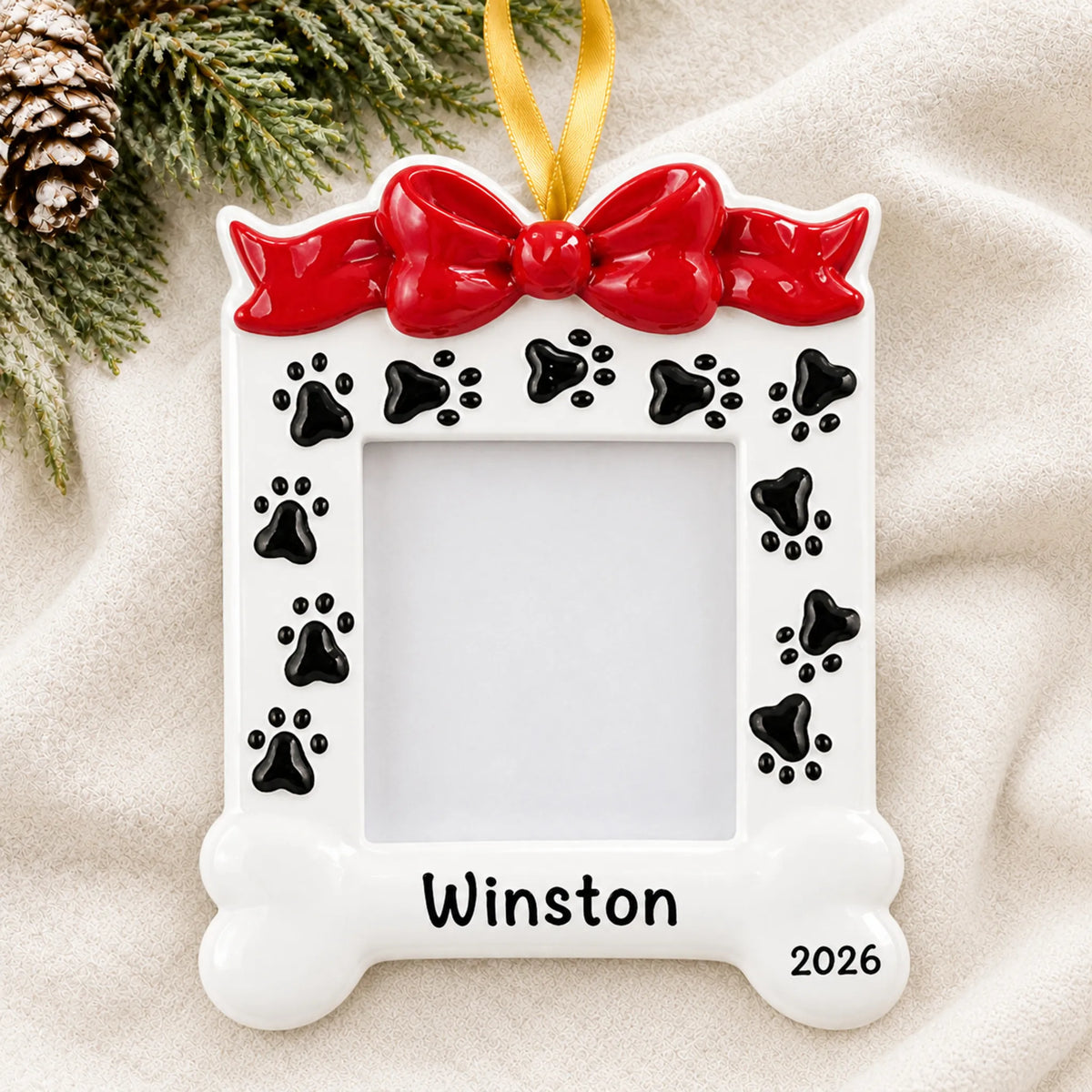 Personalized Dog Photo Frame christmas ornament laid on a soft white knit blanket