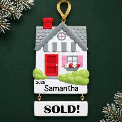Personalized Real Estate Sold House christmas ornament on a dark green pine background