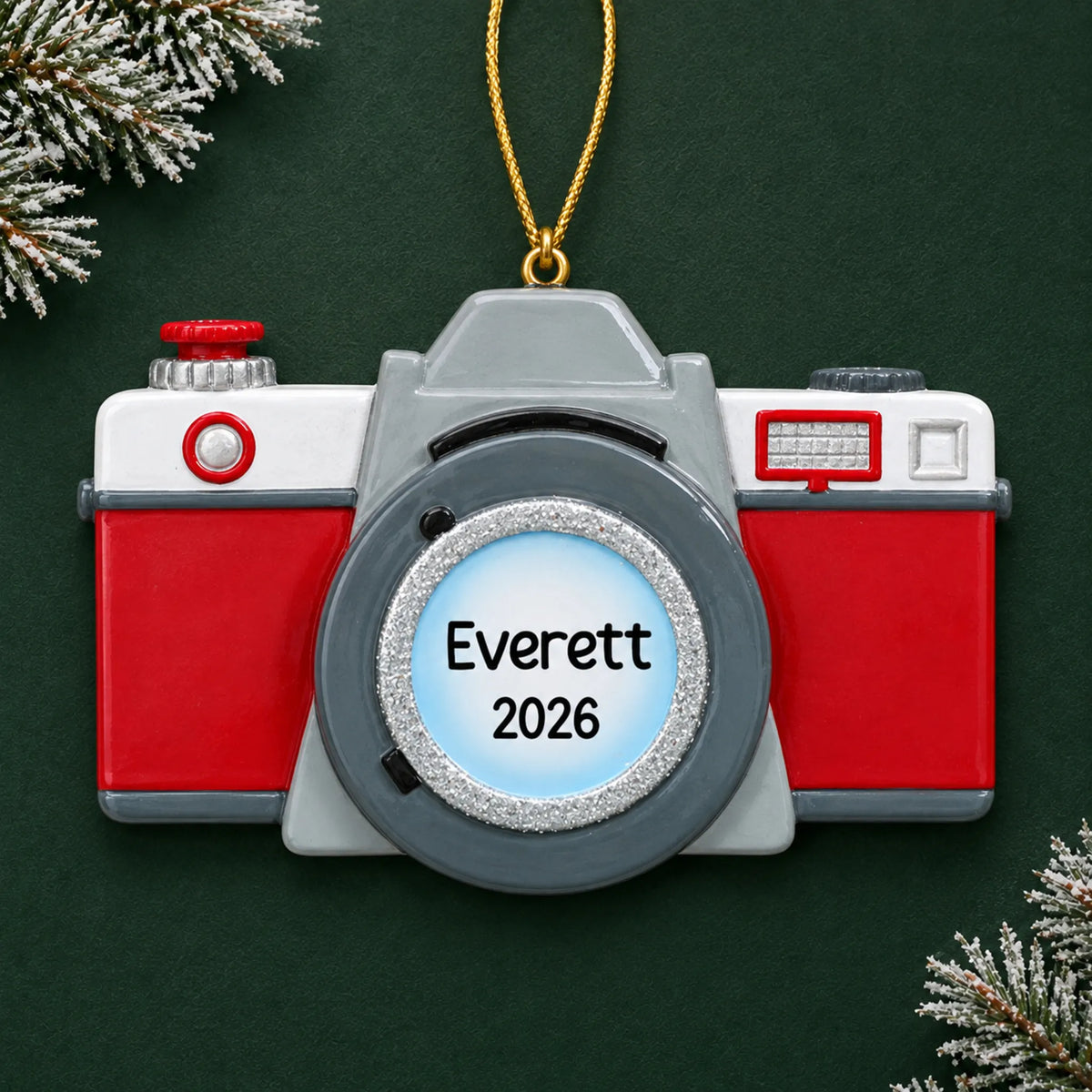 Personalized camera christmas ornament on a dark green pine background