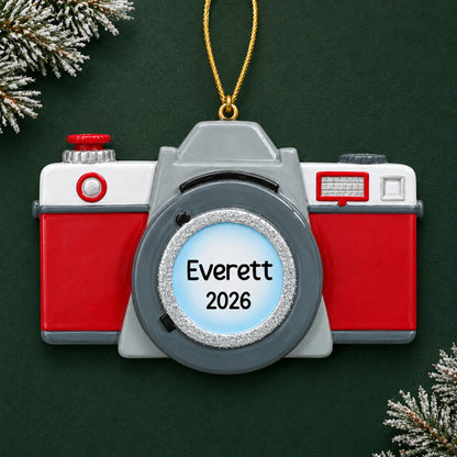 Personalized camera christmas ornament on a dark green pine background