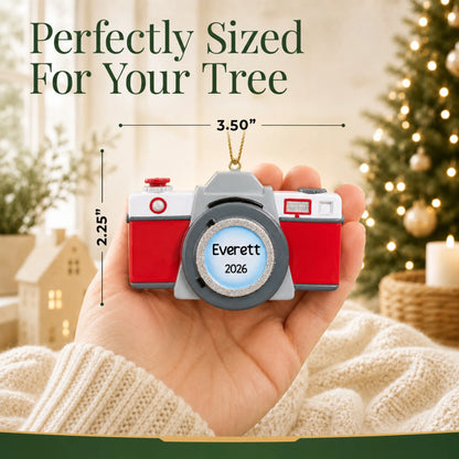 Size guide: the personalized camera christmas ornament is 3.50 in wide by 2.25 in tall, shown in hand