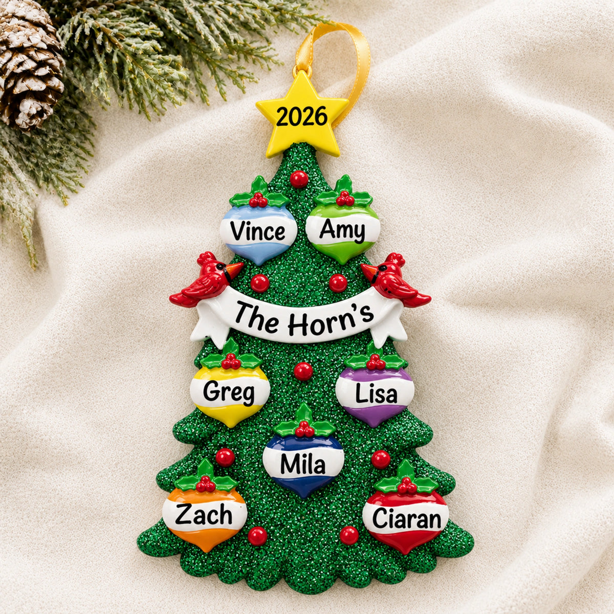 Personalized green glitter tree family of 7 christmas ornament with seven names on a soft blanket