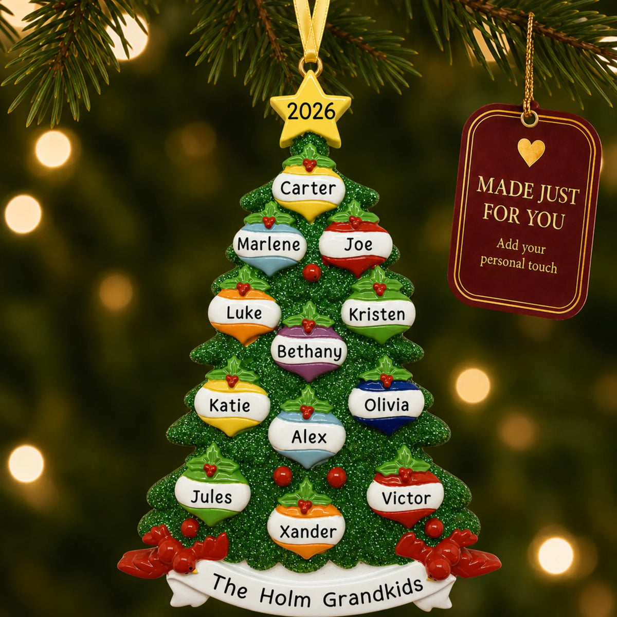 Green glitter tree family of 12 christmas ornament hanging on a lit Christmas tree with a Made Just For You gift tag