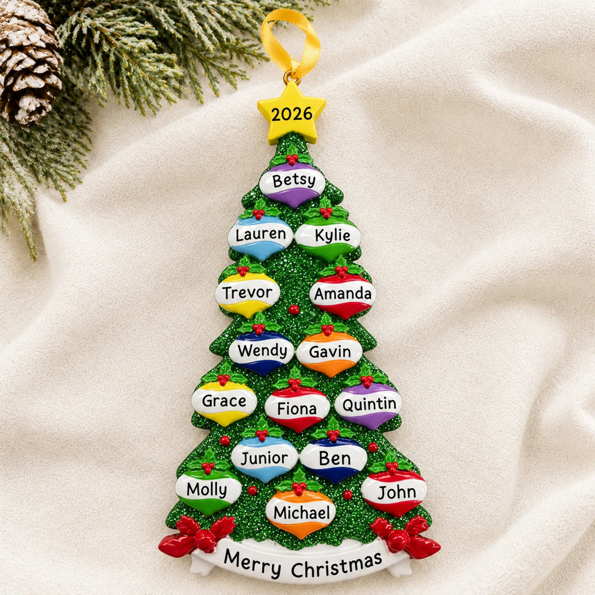 Personalized green glitter tree family of 15 christmas ornament laid on a soft white knit blanket