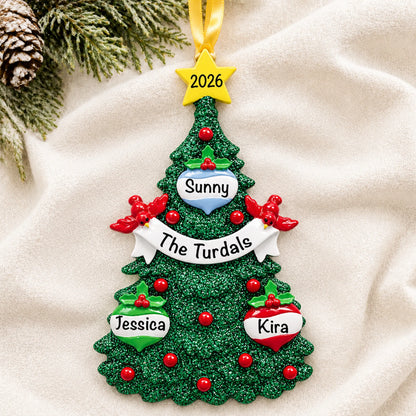 Personalized green glitter tree family of 3 christmas ornament laid on a soft white knit blanket