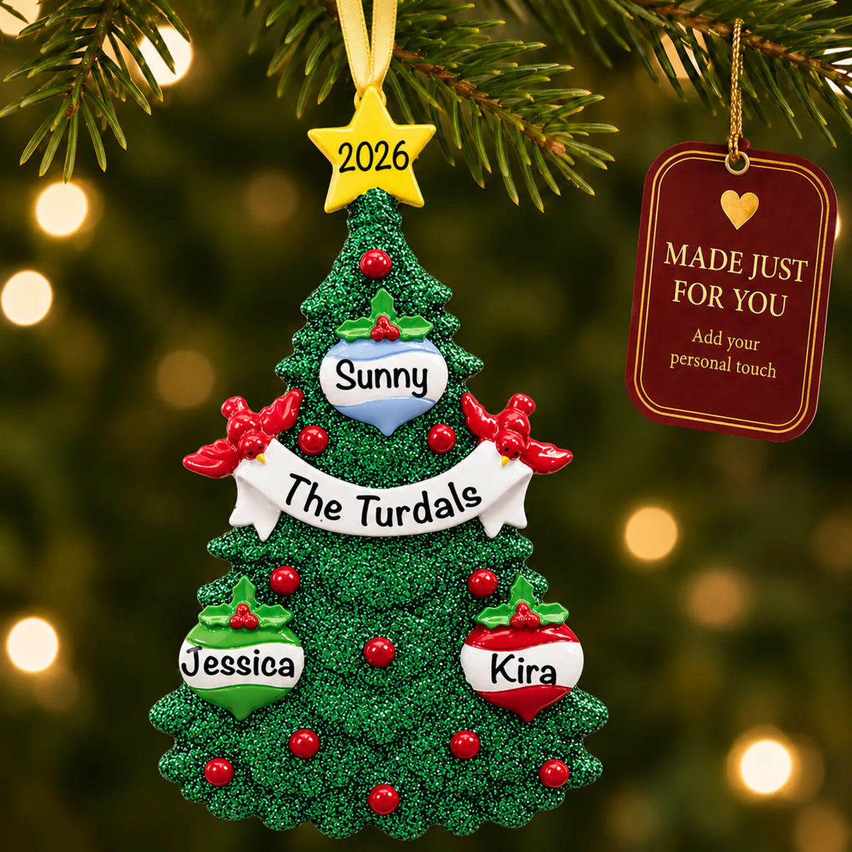 Green glitter tree family of 3 christmas ornament hanging on a lit Christmas tree with a Made Just For You gift tag