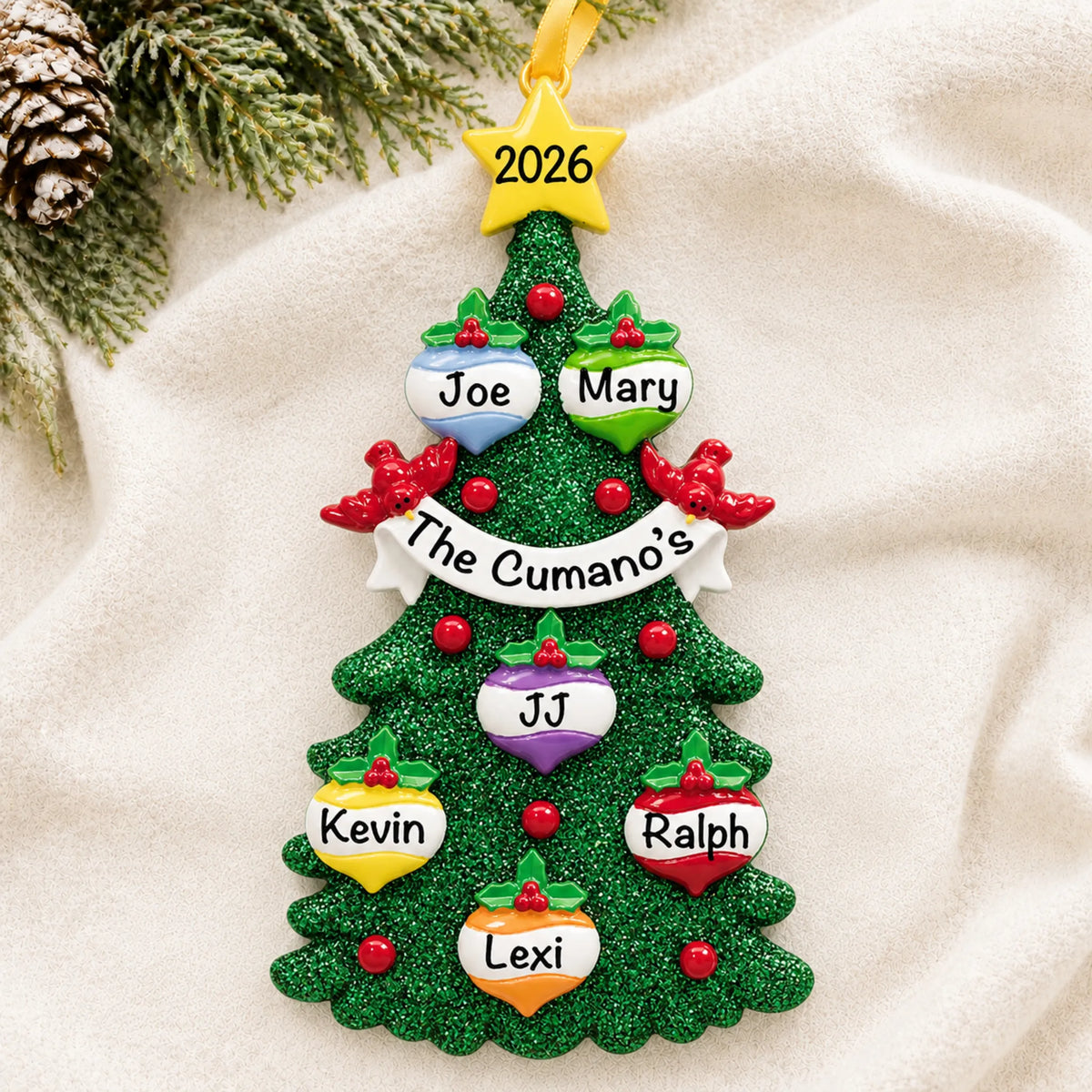 Personalized green glitter tree family of 6 christmas ornament laid on a soft white knit blanket