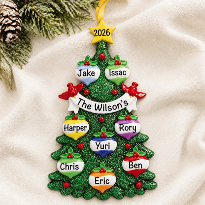 Personalized green glitter tree family of 8 christmas ornament laid on a soft white knit blanket