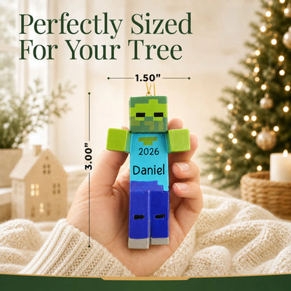 Size guide: the personalized 3d blocky video game zombie christmas ornament is 1.50 in wide by 3.00 in tall, shown in hand