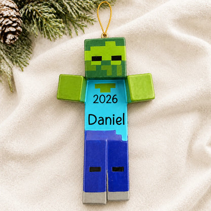 Personalized 3d blocky video game zombie christmas ornament laid on a soft white knit blanket