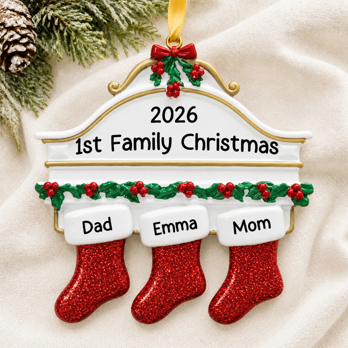 Personalized red stockings family of 3 christmas ornament laid on a soft white knit blanket