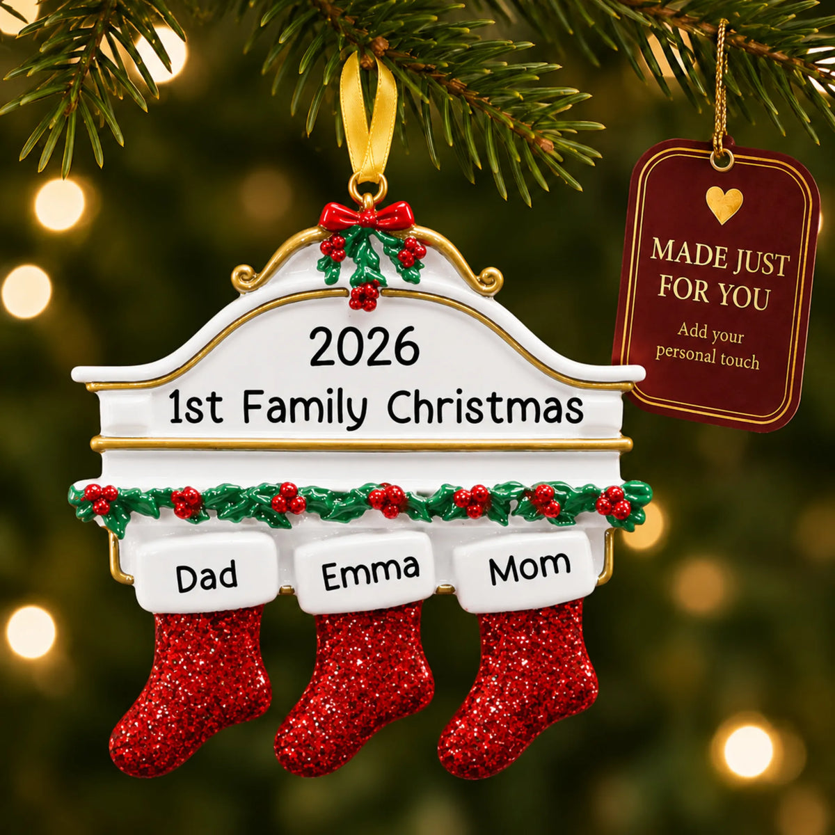 Red stockings family of 3 christmas ornament hanging on a lit Christmas tree with a Made Just For You gift tag