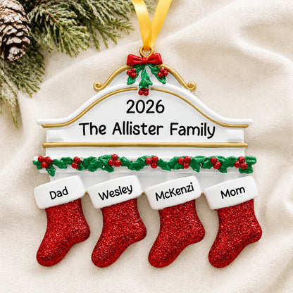Personalized red stockings family of 4 christmas ornament laid on a soft white knit blanket