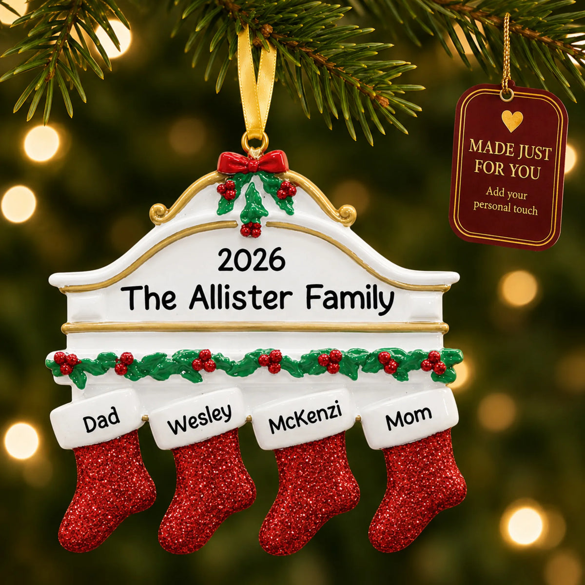 Red stockings family of 4 christmas ornament hanging on a lit Christmas tree with a Made Just For You gift tag