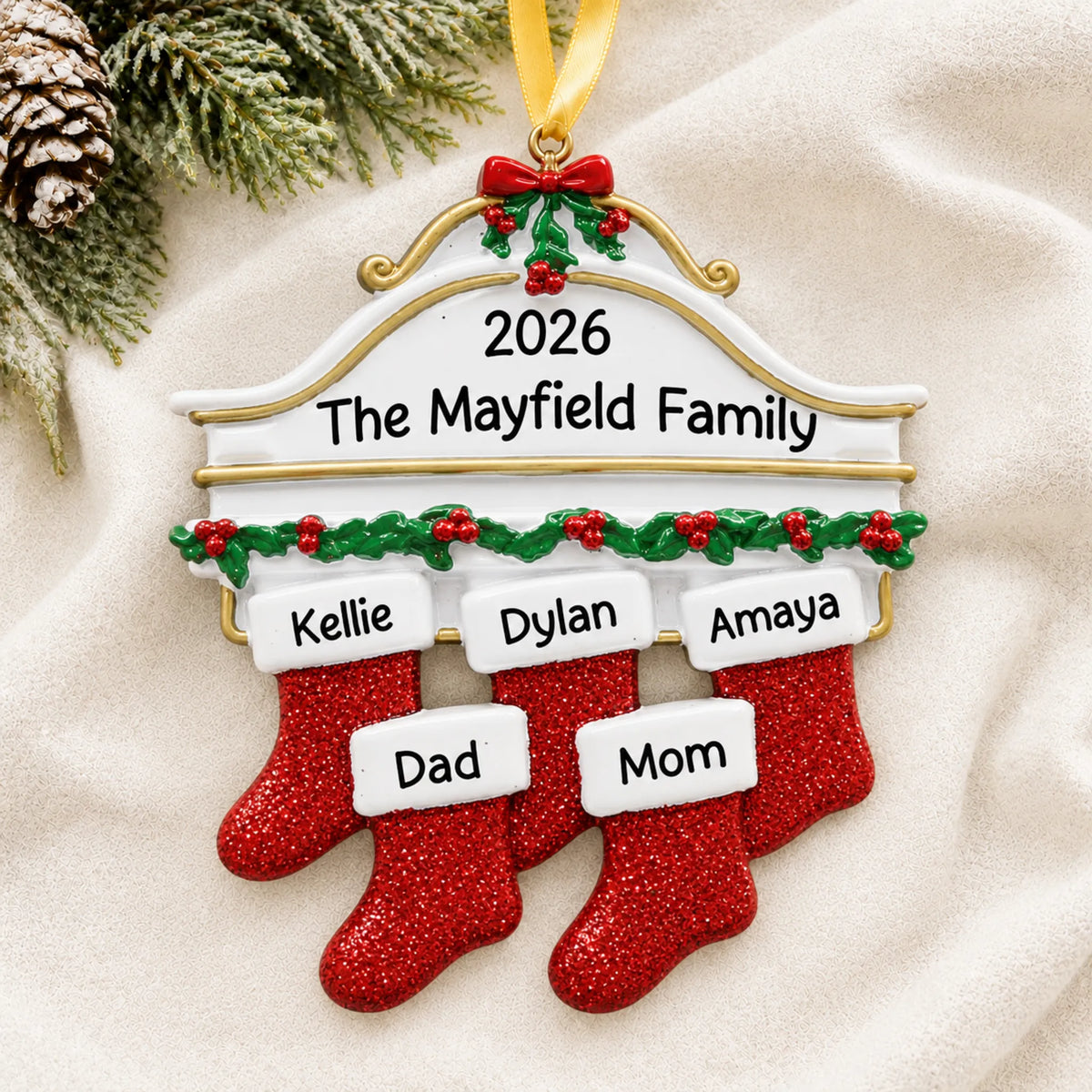 Personalized red stockings family of 5 christmas ornament laid on a soft white knit blanket