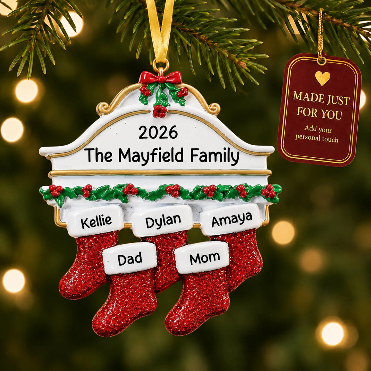 Red stockings family of 5 christmas ornament hanging on a lit Christmas tree with a Made Just For You gift tag