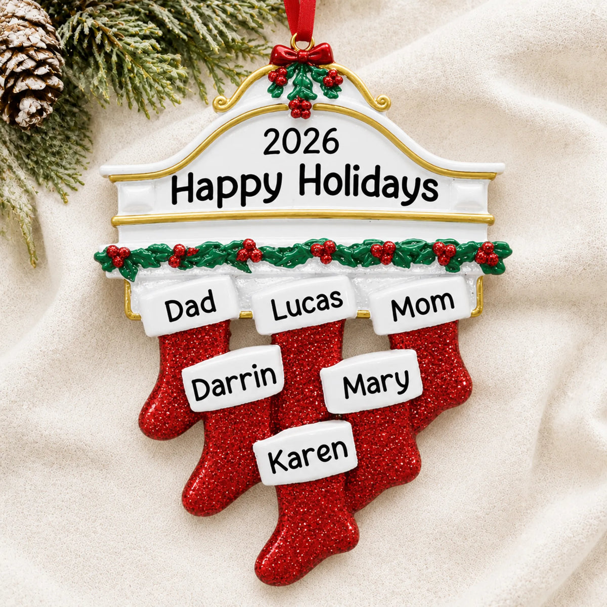 Personalized red stockings family of 6 christmas ornament laid on a soft white knit blanket