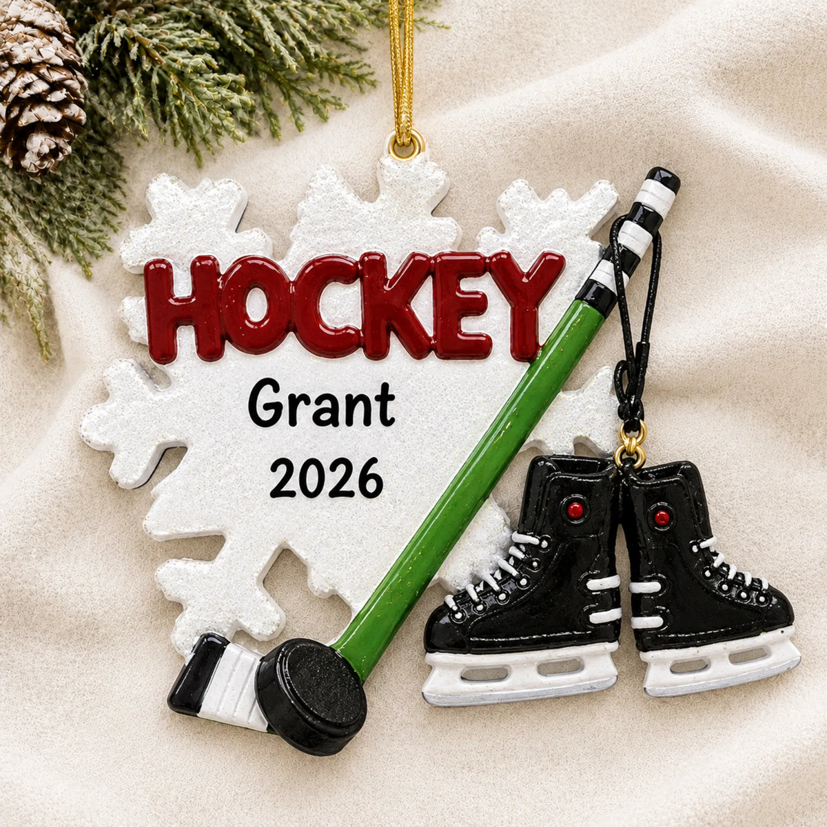 Personalized Ice Hockey Snowflake christmas ornament laid on a soft white knit blanket