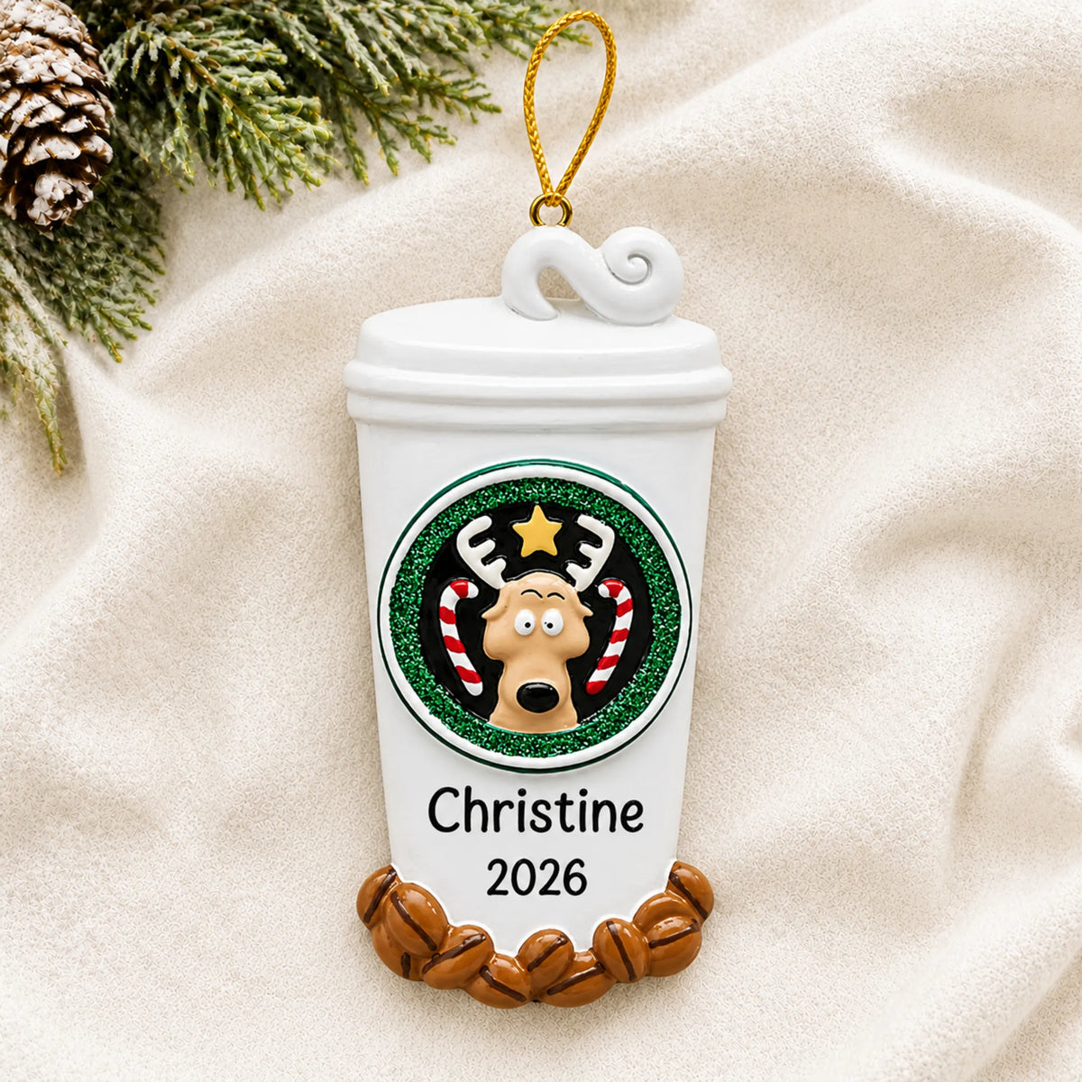 Personalized Coffee Lover To-Go Cup christmas ornament laid on a soft white knit blanket